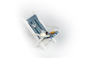 Sun lounger isolated on white background. Tropical vacation background. Sun lounger on the sandy island, copy space, front view