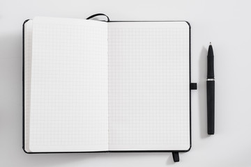 Management and planning. Office worker essentials. Flat lay of blank note book and pen on white background. Mockup. Copy space.
