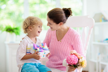 Happy mother’s day. Child with present for mom.