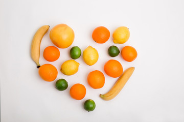 heart made from different fruits on white background