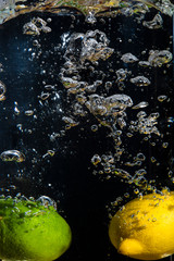 lemon and lime underwater with bubbles