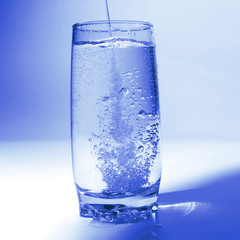 water pouring in transparent glass with bubbles of air