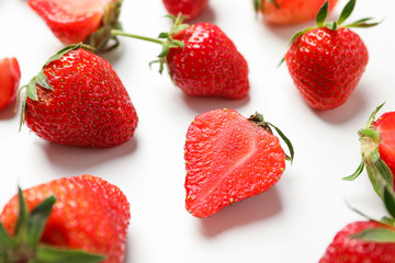 Composition with strawberries on white background, closeup. Summer sweet fruits and berries