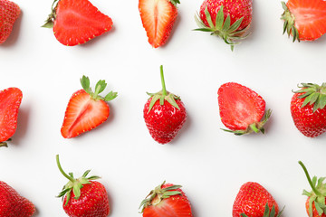 Flat lay composition with strawberries on white background, closeup. Summer sweet fruits and berries