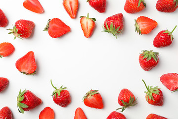 Flat lay composition with strawberries on white background, space for text. Summer sweet fruits and berries
