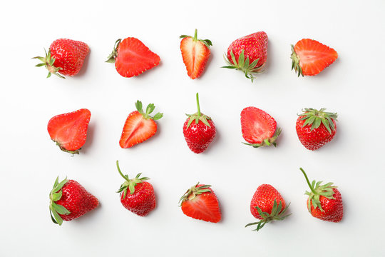 Flat lay composition with strawberries on white background, space for text. Summer sweet fruits and berries