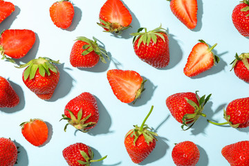 Flat lay composition with strawberries on color background, closeup. Summer sweet fruits and berries