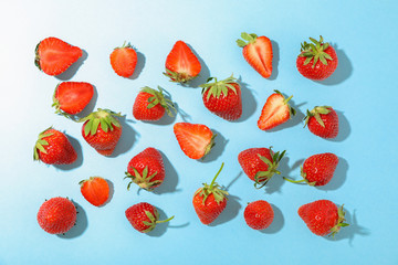 Flat lay composition with strawberries on color background, space for text. Summer sweet fruits and berries
