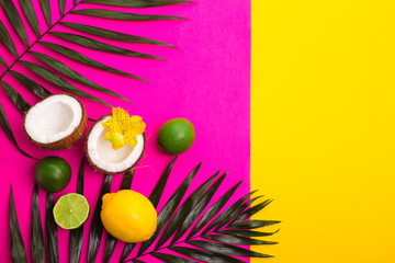 Fototapeta na wymiar Tropical bright colorful background with exotic tropical palm leaves., coconuts, lime, lemon.