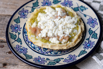 Mexican food: sopes with green sauce and beans