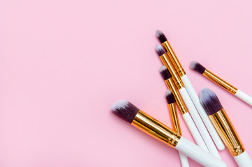 Set of makeup brushes on pink background. Top view point, flat lay. Top view