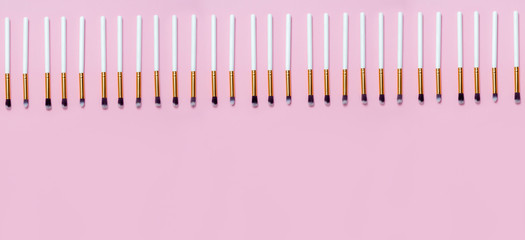 Set of makeup brushes on pink background. Top view point, flat lay. Top view