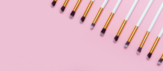 Set of makeup brushes on pink background. Top view point, flat lay. Top view