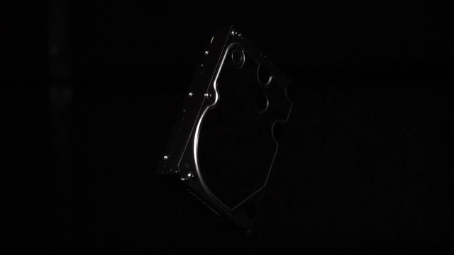 Hard disk drive spinning fast in space isolated on black background
