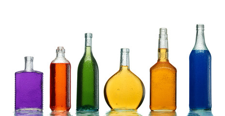 Various alcoholic drinks in transparent bottles