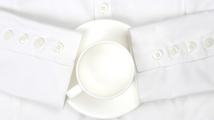 empty white coffee Cup and saucer on a white shirt
