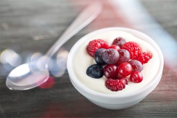 Yogurt with forest berries  on wooden table