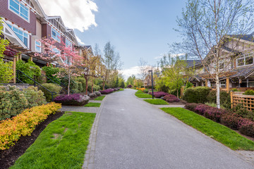 Fgrament of beautiful exterior of newly built luxury home. Yard with green grass and landscape.