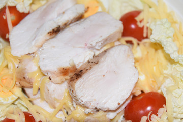 homemade caesar salad in large bowl abstract background chicken cheese tomatoes