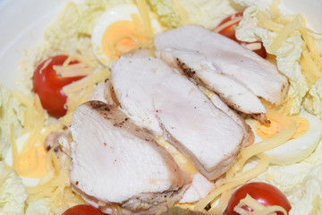 homemade caesar salad in large bowl abstract background chicken cheese tomatoes