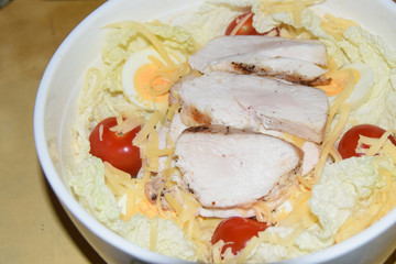 homemade caesar salad in large bowl abstract background chicken cheese tomatoes