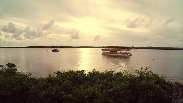 Boat and Tourist Catamaran on the sunset of Praia do Jacare - Alligator beach. Cabedelo - PB Paraiba, Brazil.