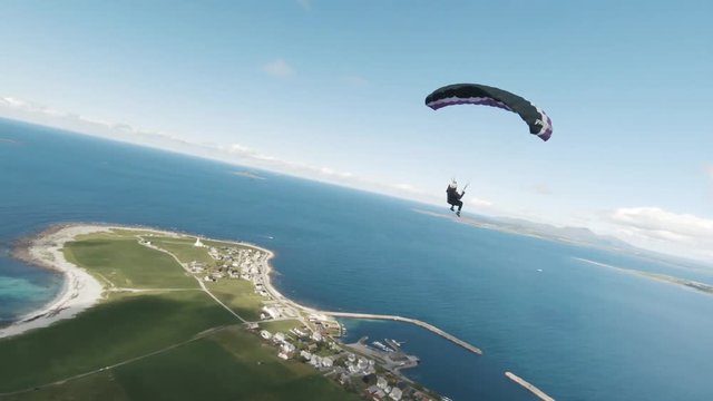 Breathtaking aerial footage of paraglider over the sea