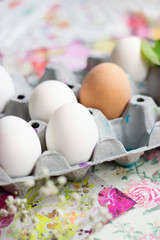 White eggs in the cardboard box, prepared for decorating; Easter background