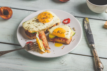 Toasts with vegetables and fried egg and cup of coffee