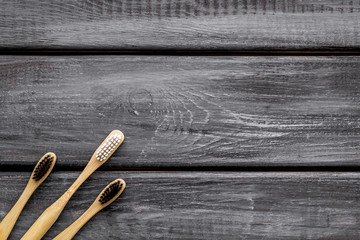 Dental care with eco friendly bamboo tooth brush on wooden background top view space for text