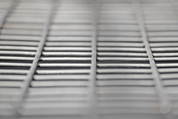 abstract silver metal grid closeup, industry diversity