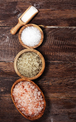 sea salt in bowl. Crystals of salt on table and himalayan salt.