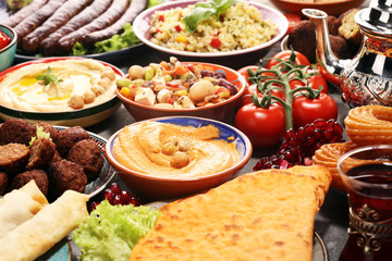 Middle eastern or arabic dishes and assorted meze, concrete rustic background. Falafel. Turkish Dessert Baklava with pistachio. Halal food. Lebanese cuisine