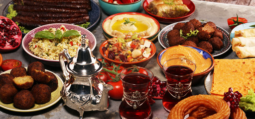 Middle eastern or arabic dishes and assorted meze, concrete rustic background. Falafel. Turkish Dessert Baklava with pistachio. Halal food. Lebanese cuisine