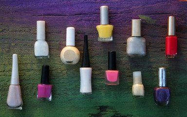 Assorted nail polishes on wooden background - 270119783