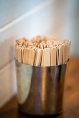 Paddle pop sticks in a metal container at a cafe