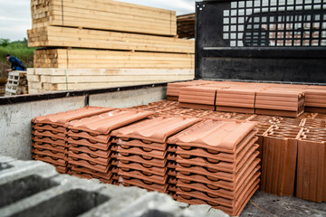 Clay tile and brick blocks concrete at the warehouse loaded in the back of the truck ready for the delivery to the construction site