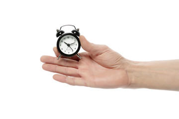 Male hand holds a clock shows the time on a white isolated background.