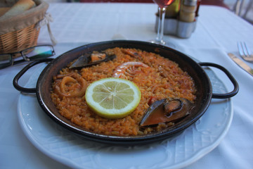 Traditional Spanish dish - paella with shrimp, mussels and lemon