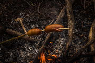 sausages fried on a fire