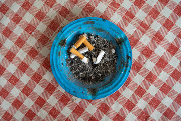 Cigarette butts end stubs in the ash tray on the table quitting smoke health lung high angle view
