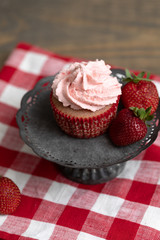 Homemade Strawberry Cupcake Isolated on Stand; Red Checked Napkin; Wooden Table; Fresh Strawberries