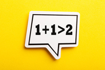 Synergy 1+1>2 Speech Bubble Isolated On Yellow Background