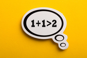 Synergy 1+1>2 Speech Bubble Isolated On Yellow Background