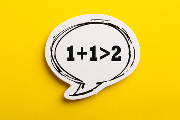 Synergy 1+1>2 Speech Bubble Isolated On Yellow Background