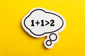 Synergy 1+1>2 Speech Bubble Isolated On Yellow Background