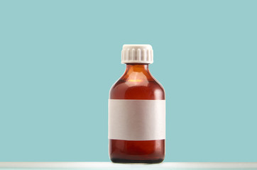 Glass bottle with label for medicinal infusions on a blue background.