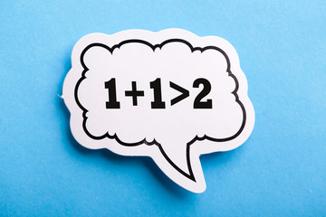 Synergy 1+1>2 Speech Bubble Isolated On Blue Background