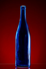 Dark glass bottle on red background