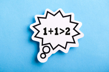 Synergy 1+1>2 Speech Bubble Isolated On Blue Background